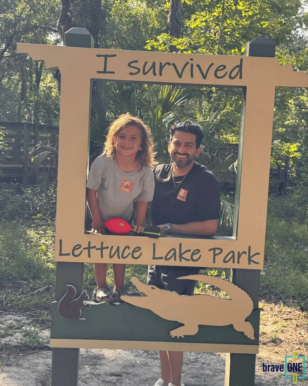 A mentor and mentee posing in an “I survived Lettuce Lake Park” photo frame