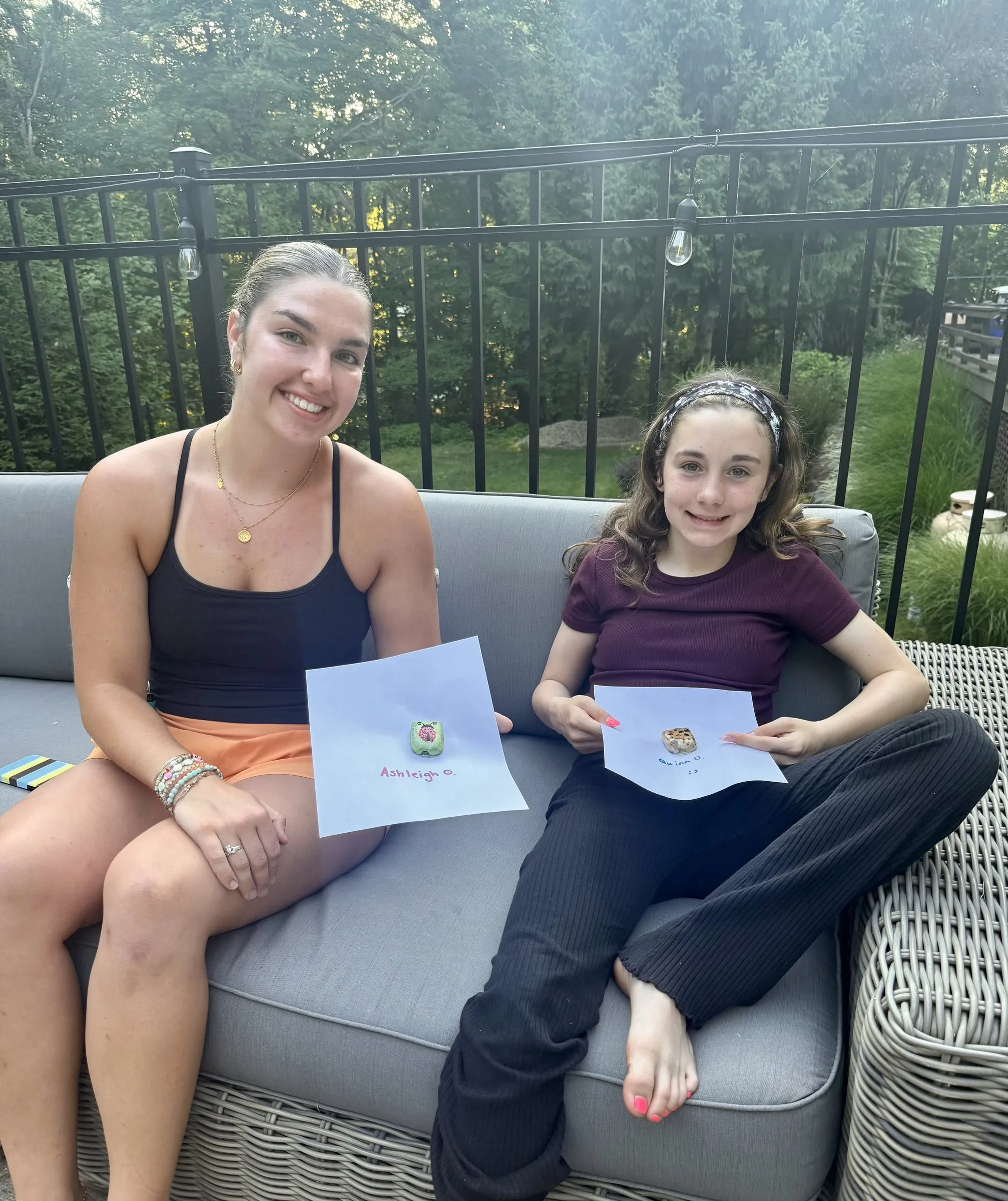 A mentor and mentee relaxing on a patio with their letters