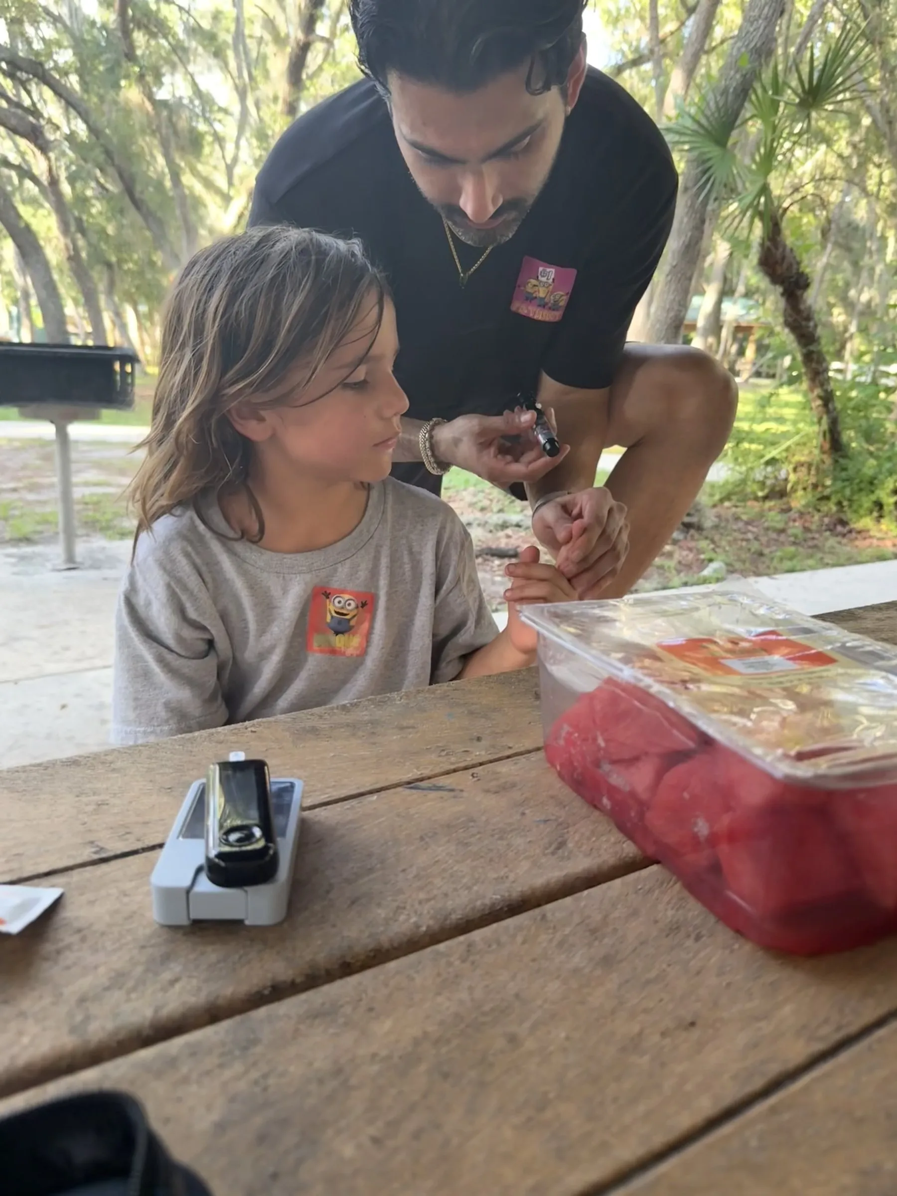 A mentor and his mentee at a park picnic table