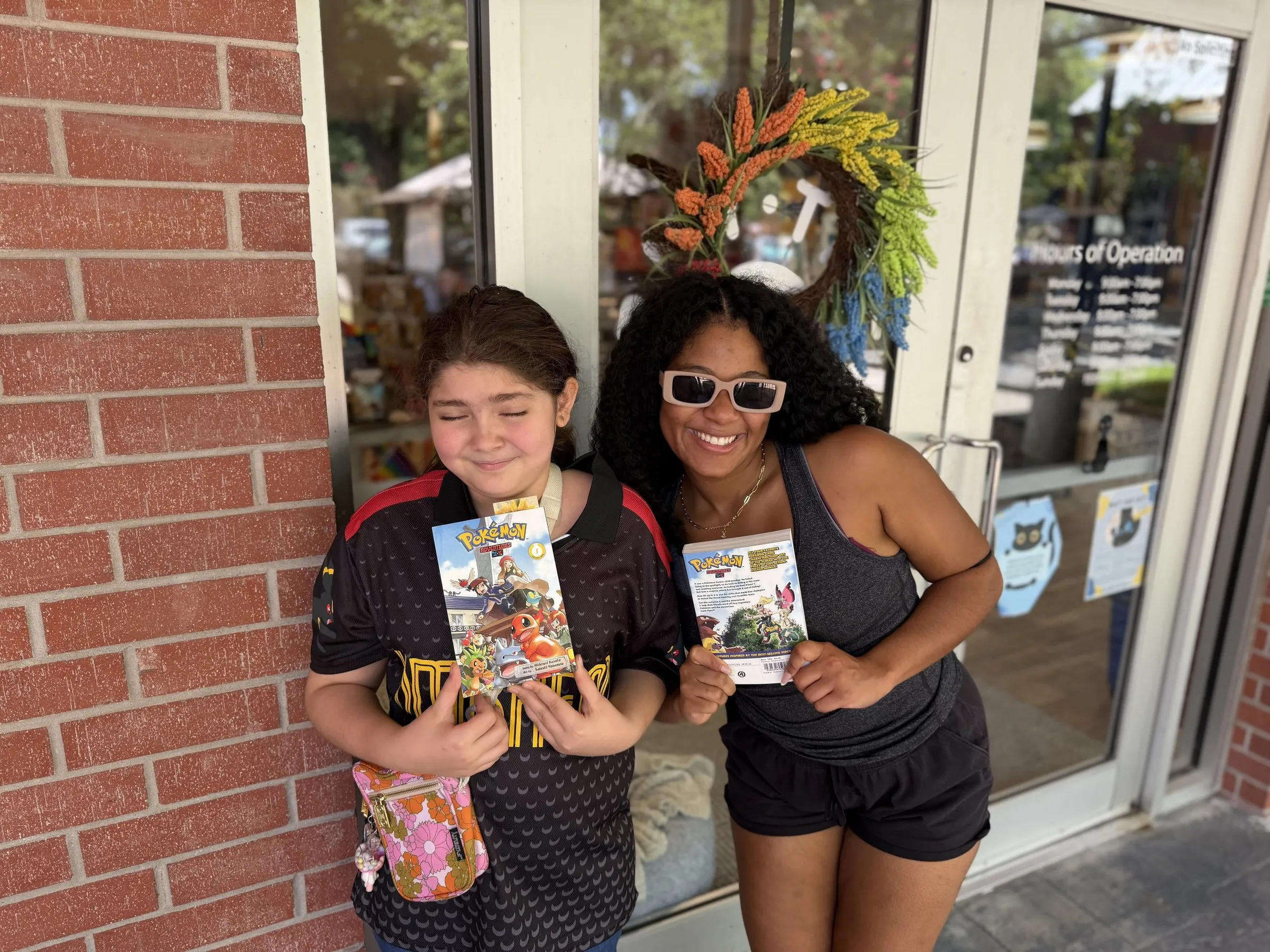 A braveONE mentee and her mentor showing off their finds outside a shop