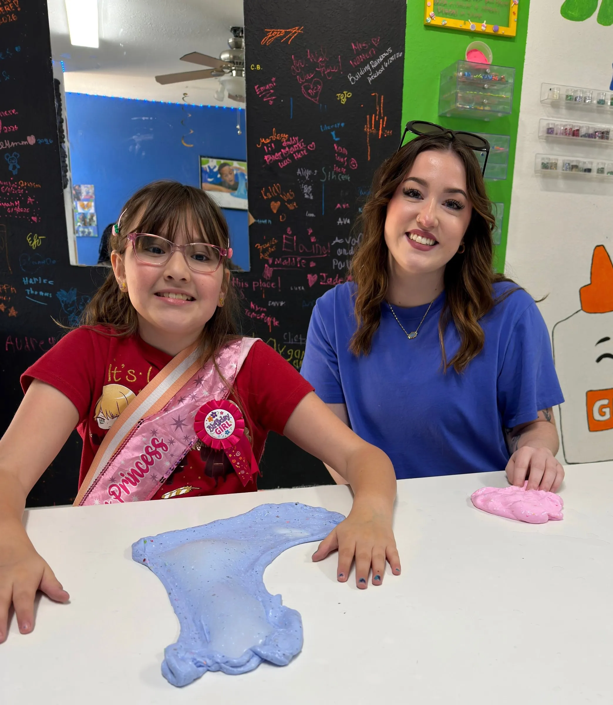 A braveONE mentee and her mentor smiling together at a slime-making outing