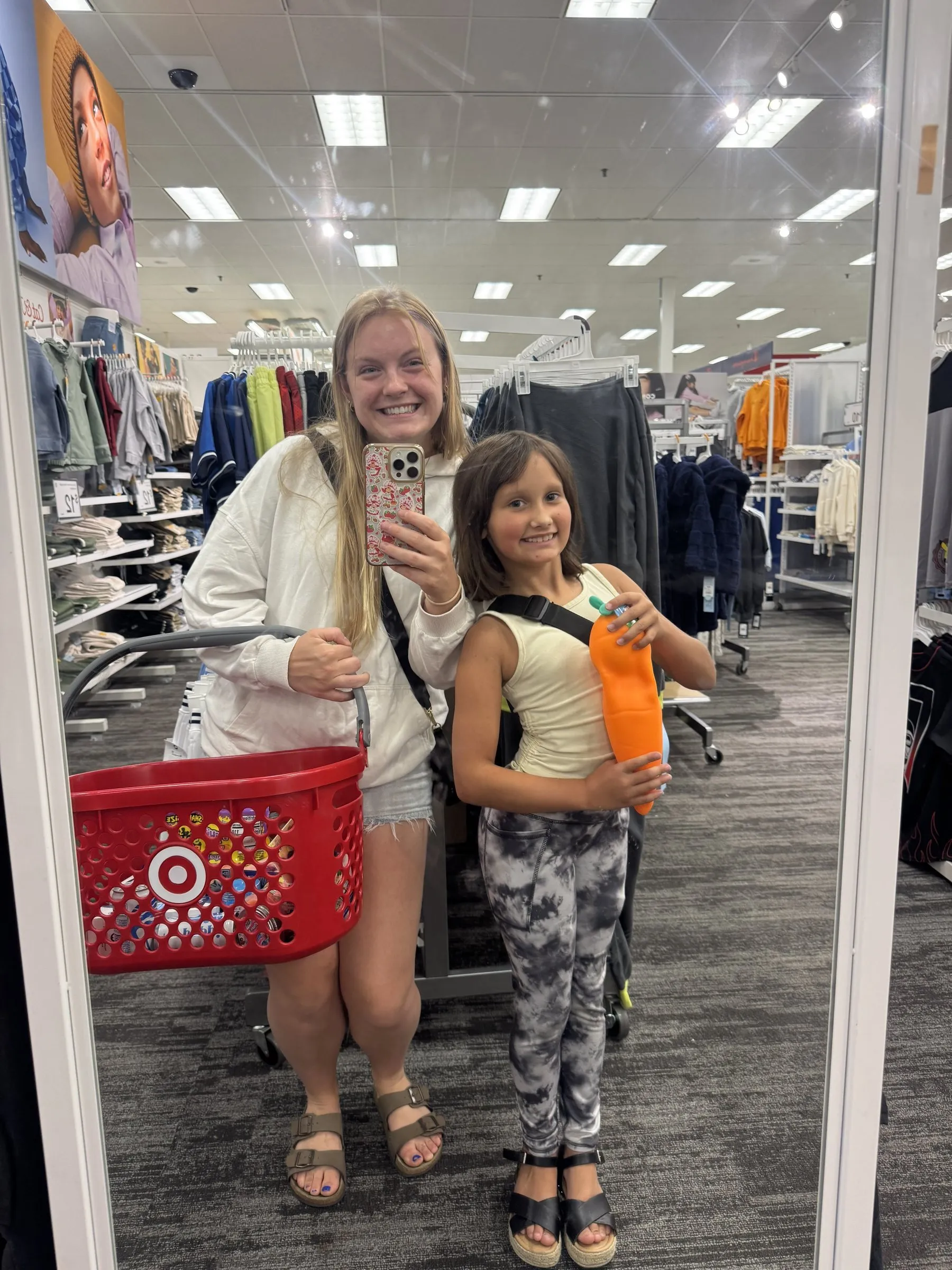 A mentor and mentee taking a mirror selfie on a shopping trip